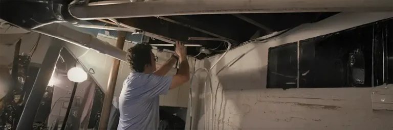 Plumber inspecting pipes for low water pressure